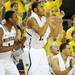 Michigan freshman Glenn Robinson III and sophomore Jon Horford cheer from the bench after senior Eso Akunne made a three-point basket during the second half of an NIT Season Tip-Off game at Crisler Center on Tuesday. Melanie Maxwell I AnnArbor.com